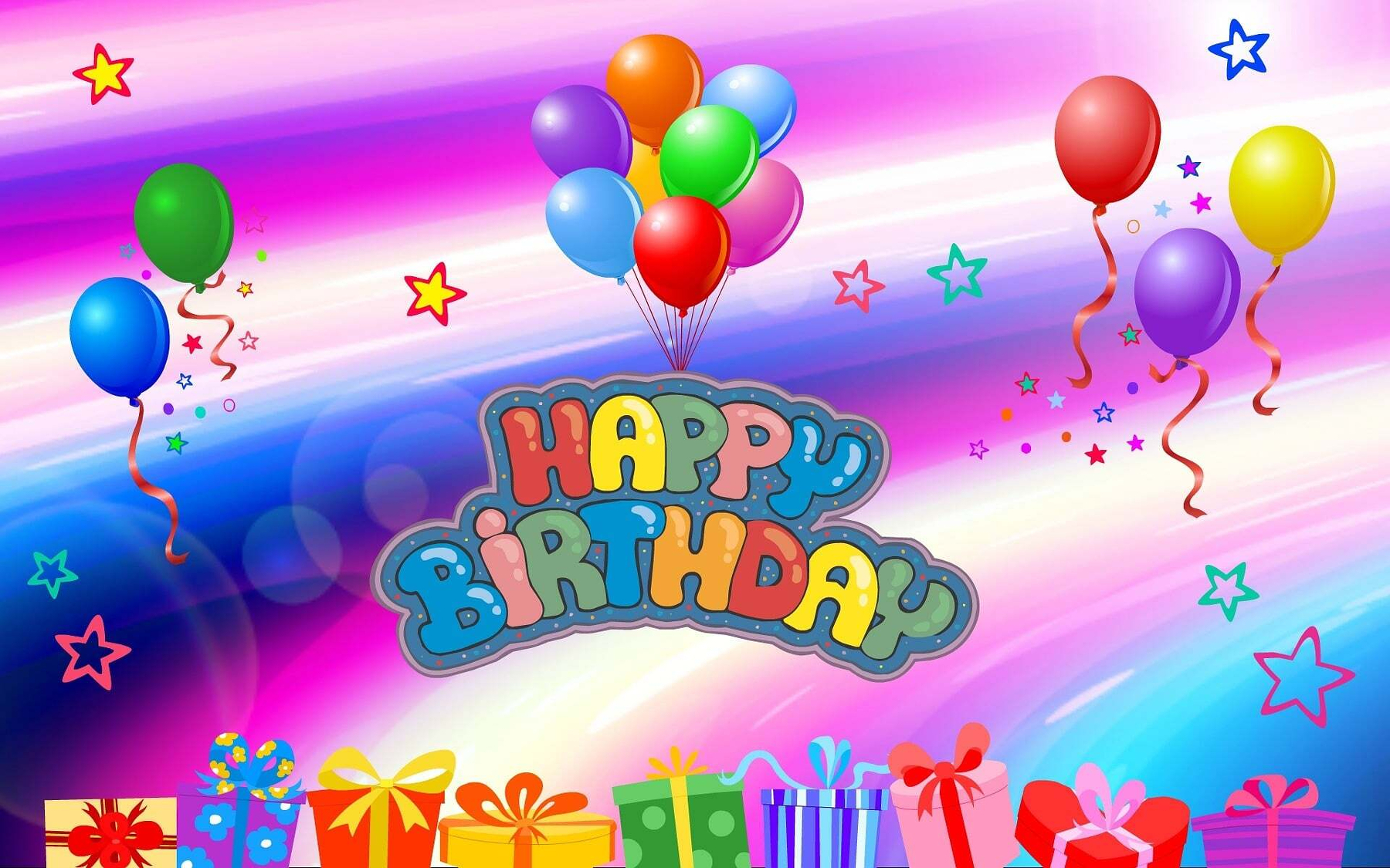 Auto-generated description: Colorful balloons and gift boxes surround a vibrant Happy Birthday sign against a bright, star-filled background.